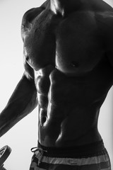 Fototapeta na wymiar Side-view silhouette of young muscular athletic sexy shirtless hot man posing showing sport body with cool pectoral abs muscle strong breast biceps studio black and white. Beads sweat training gym. 