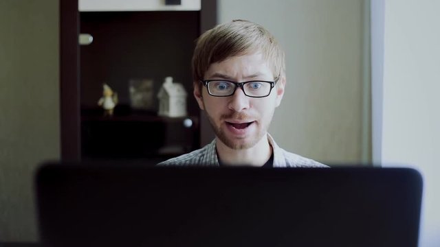 the guy in front of a laptop is very angry and swears