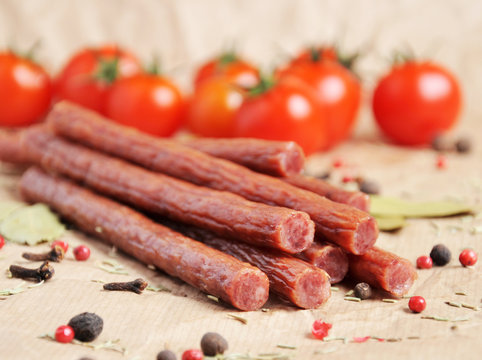 Beef sticks, sausages on a paper background