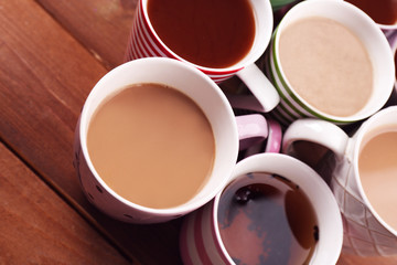 Obraz na płótnie Canvas Cups of cappuccino on wooden table, closeup