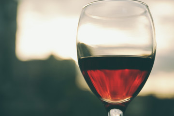 Glass of red wine on blurred background
