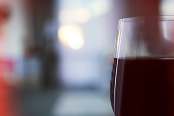 Glass of red wine on blurred background