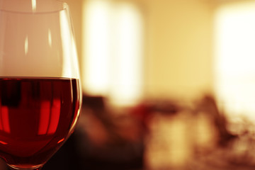 Glass of red wine on blurred background