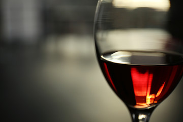 Glass of red wine on blurred background