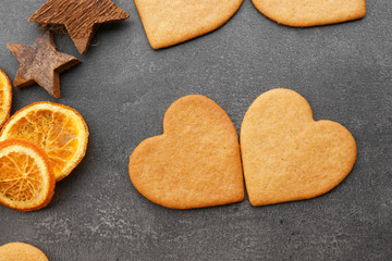 Heart shaped biscuits on grey background, top view