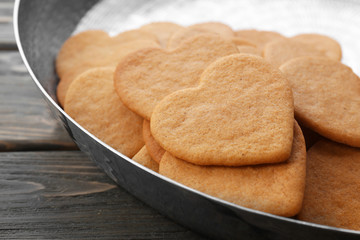 Heart shaped biscuits in baking tray, closeup