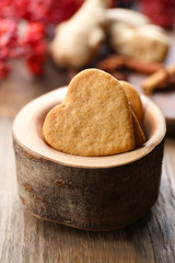 Fototapeta na wymiar Heart shaped biscuits in wooden bowl, closeup