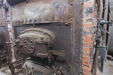 Brick coal burning boiler in machine room