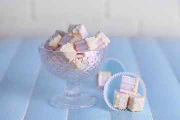 Tasty marshmallows with chocolate in bowl on table, close up