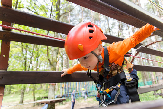 Portrait of 3 years old boy wearing helmet and climbing