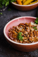 Mujadarra - arabian dish with rice, lentils and onion on dark  background. Ramadan food. Eastern cuisine. Selective focus