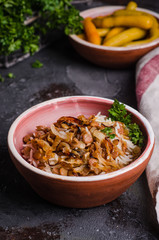 Mujadarra - arabian dish with rice, lentils and onion on dark  background. Ramadan food. Eastern cuisine. Selective focus