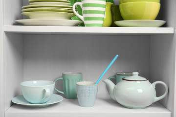 Tableware on shelves in the kitchen cupboard