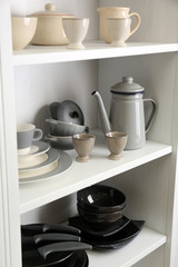 Tableware on shelves in the kitchen cupboard