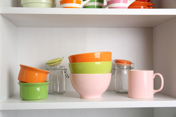 Tableware on shelves in the kitchen cupboard