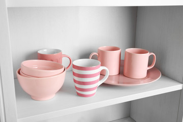 Tableware on shelf in the kitchen cupboard