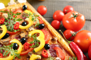 Rectangle delicious pizza and vegetables on the table, close-up