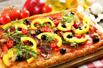 Rectangle delicious pizza and vegetables on the table