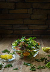 Fresh salad with vegetables on a wooden table