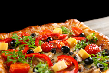 Freshly homemade pizza on black background