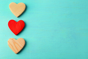 Wooden hearts on color wooden background