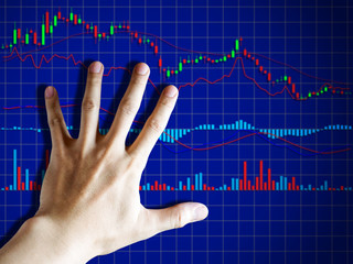 Hand with graph chart of stock market trading