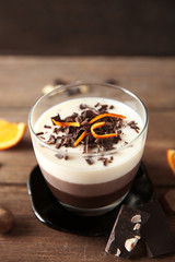 Layered dessert with decoration on wooden table