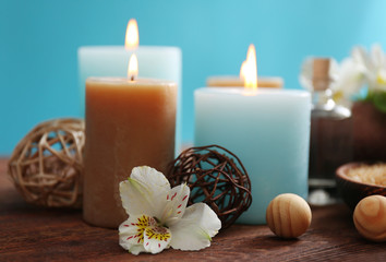 Spa set: soft towel, flowers, massage oil, candles, sea salt, close up