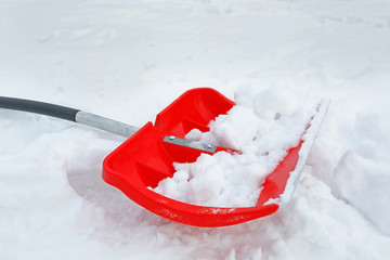 Winter concept. Red shovel for snow removal