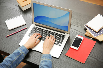 Woman working on a laptop at office desk