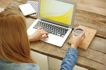 Woman working on a laptop at office desk
