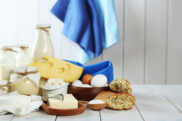 Set of fresh dairy products on white wooden table