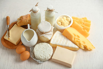 Set of fresh dairy products on white wooden table