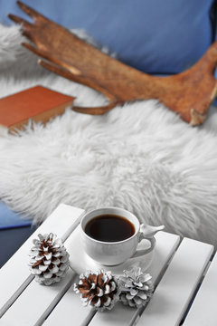Cup of hot drink in living room. Comfortable winter weekend or holidays at home