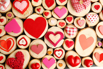 Set of different craft hearts on wooden logs