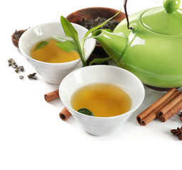 Green tea with utensils and spices, isolated on white