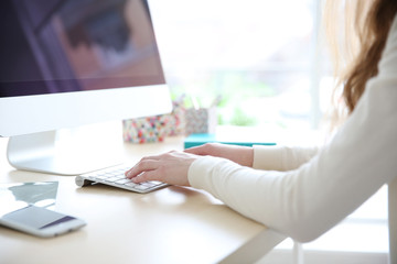 Fototapeta premium Woman working with computer at home or at office