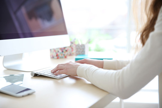 Woman working with computer at home or at office