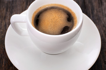 Cup of hot coffee on rustic wooden background