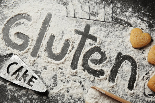 Gluten word written with flour on table