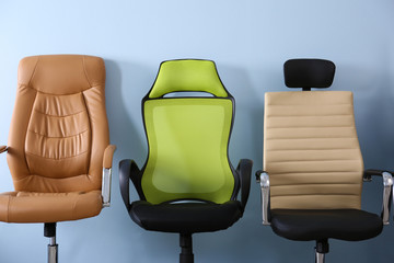 New office chairs on wall background