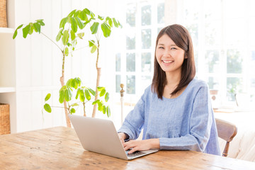 young asian woman using laptop