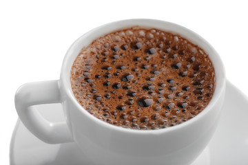 Cup of coffee with brown foam isolated on white, close up