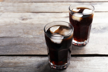 Glasses of soda water on wooden table