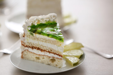 Piece of lime cake on table