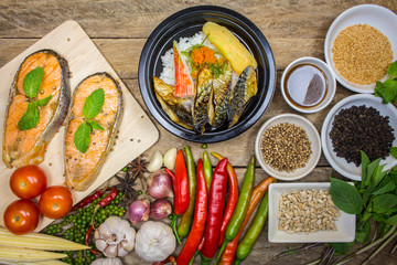 Salmon grilled fish, rice dishes with vegetables and spices in c
