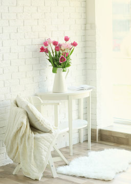 Beautiful tulips on white wooden table