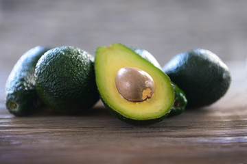 Fresh avocados on wooden background