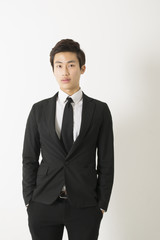 Asian young man in a black suit