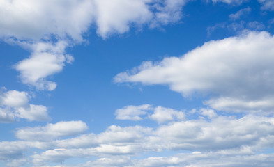 Naklejka na ściany i meble White heap clouds in the azure sky. Cloudscape over horizon.